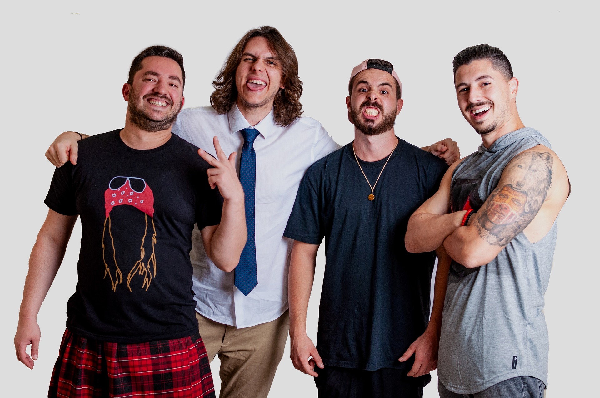 The four members of Night Parade laughing together in a studio portrait